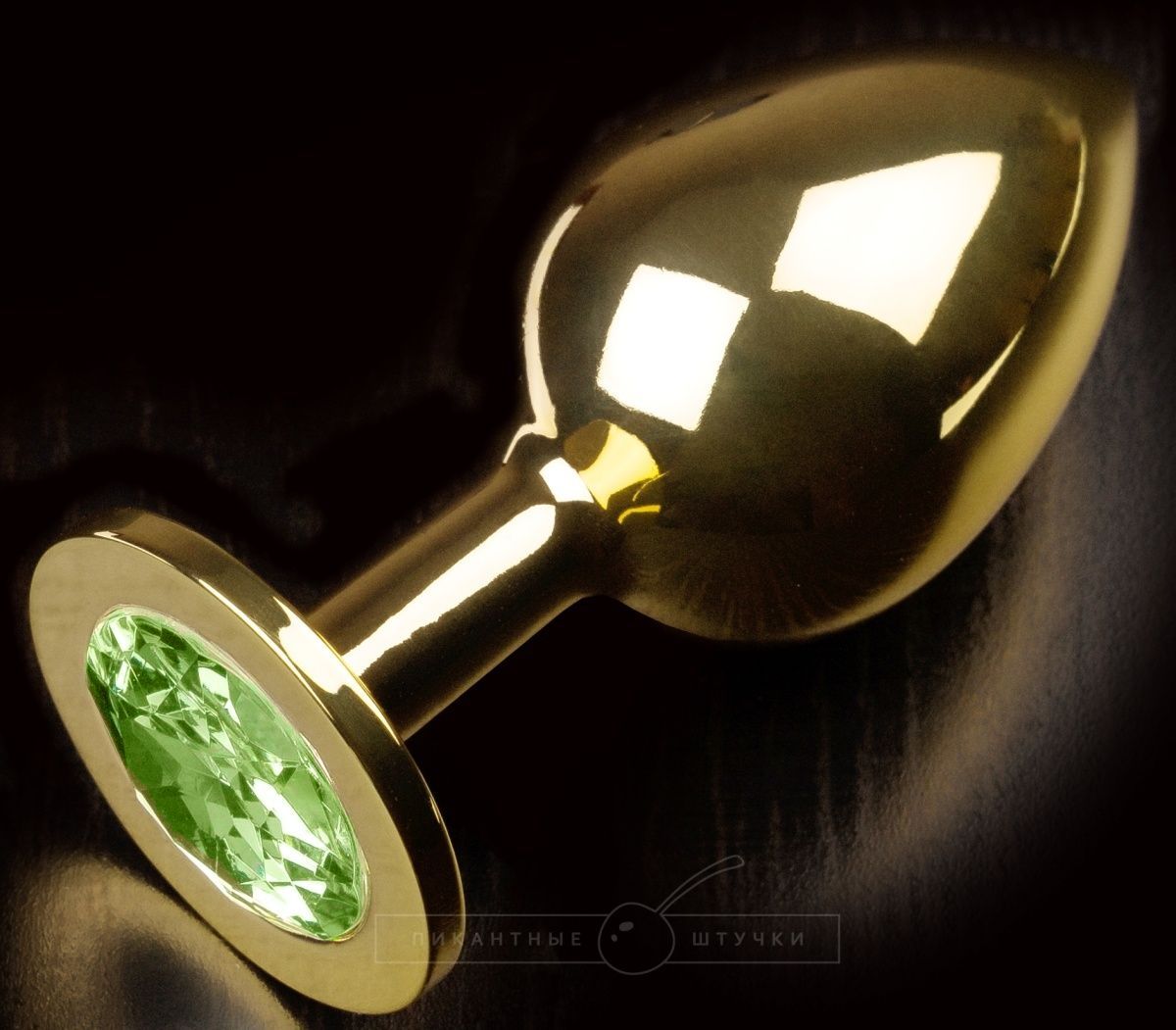 Купить Золотистая анальная пробка с салатовым кристаллом - 9 см. в Москве.